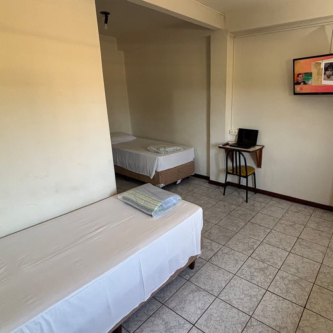 Apartamento Standard do Hotel Galli com camas, TV e mesa de trabalho